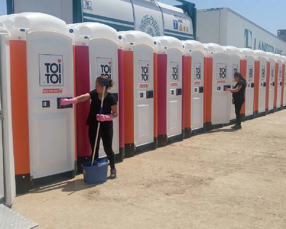 Cleaning personnel cleaning portable toilets