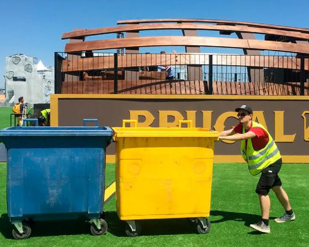 cleaning personnel pushing garbage containers